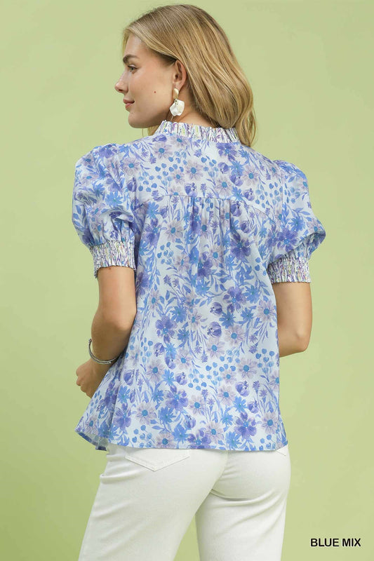 Relaxed babydoll silhouette with smocked trim